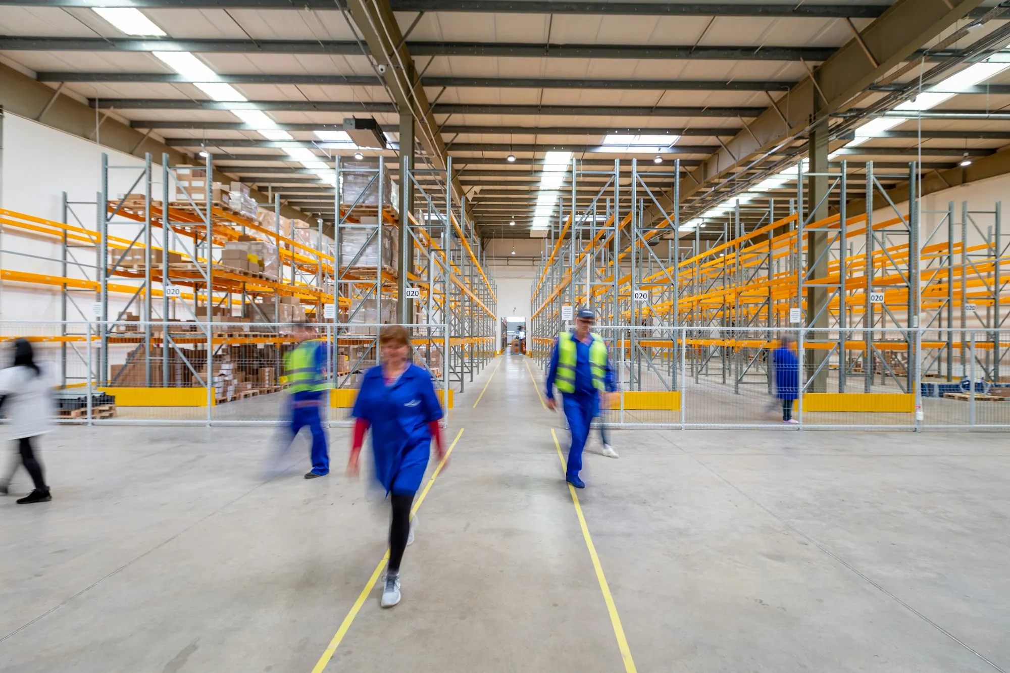 Team walking a modern warehouse aisle