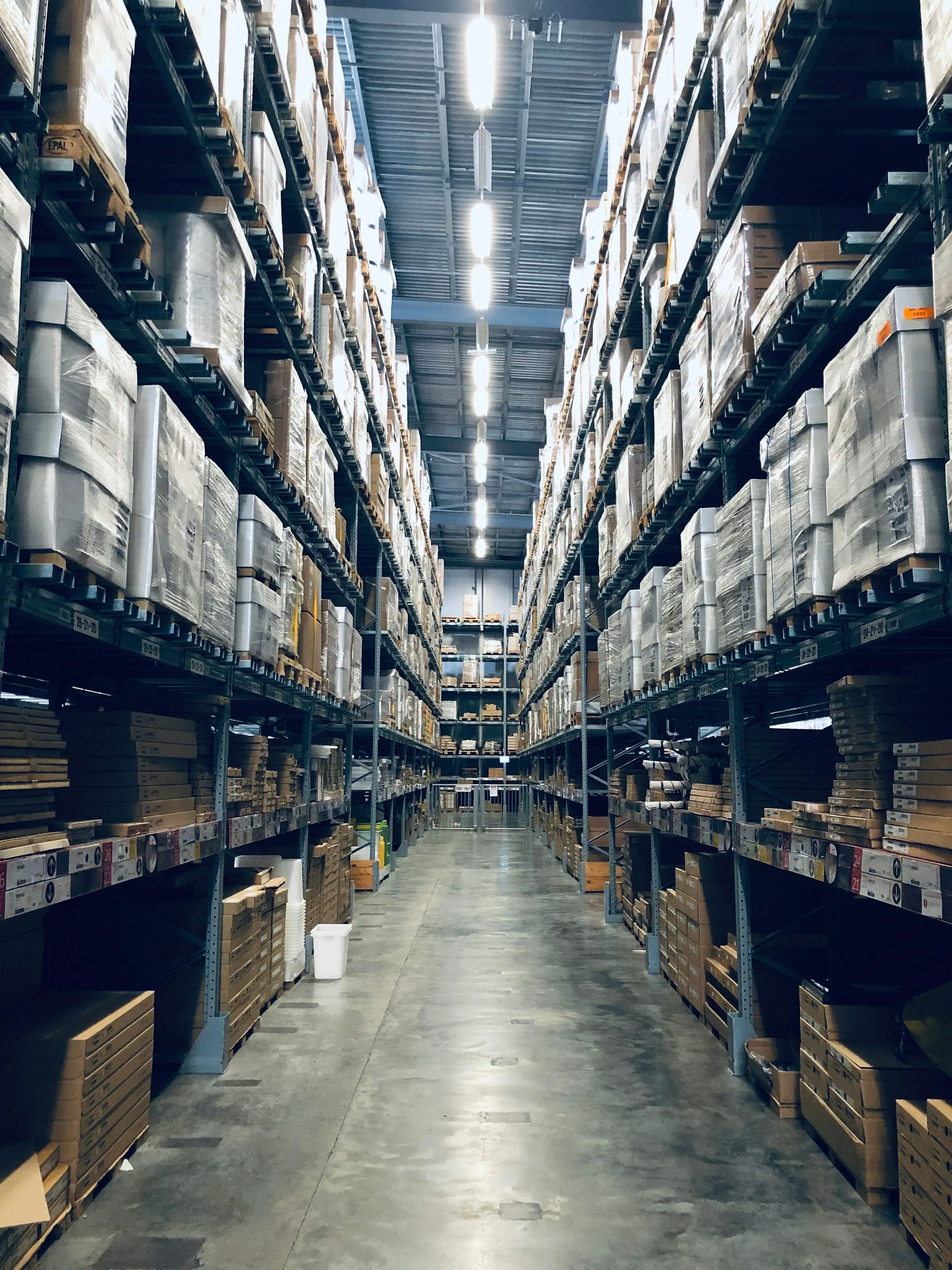 Modern fulfilment warehouse aisles stacked with stock
